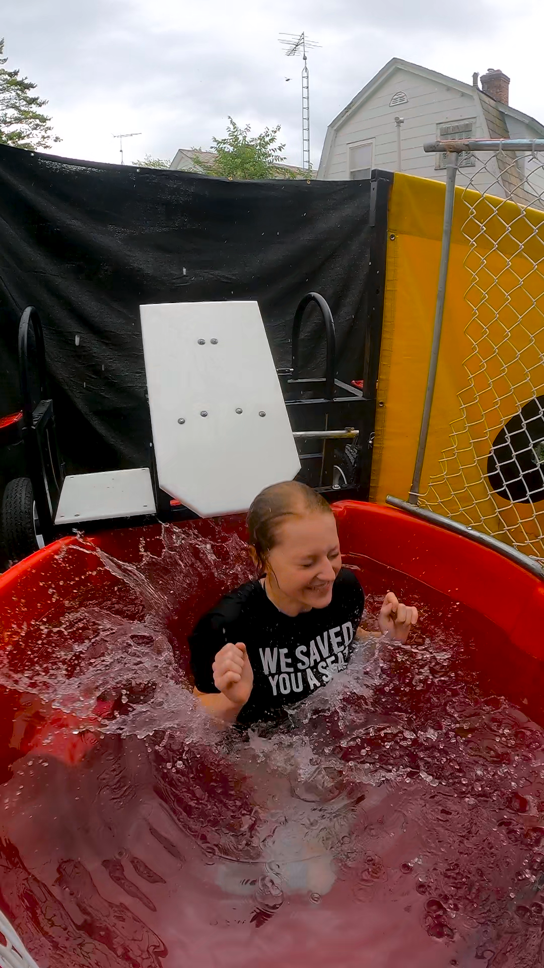 Grab the best picture dropping into a Dunk Tank rental by The Dunk Tank Company Girl dropping into dunk tank laughing